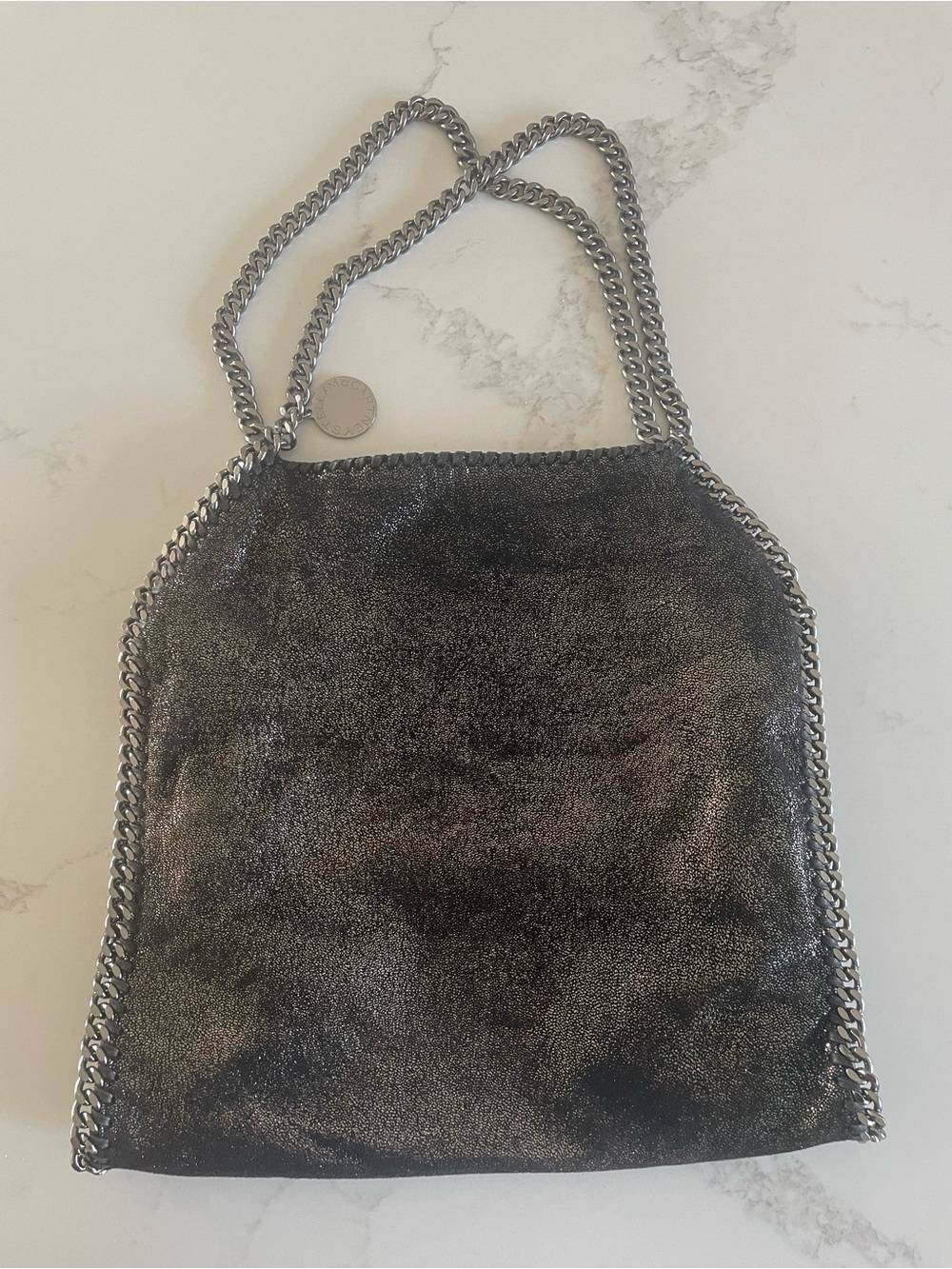 Stella McCartney Falabella Metallic gold and black bag in the shade ruthenium.